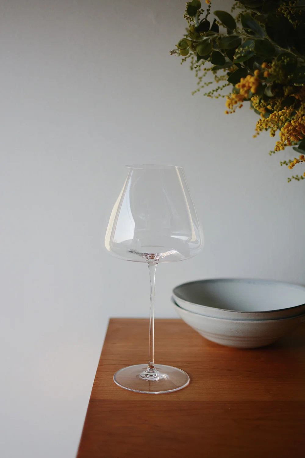 Clear wine goblets and champagne flutes on dining table